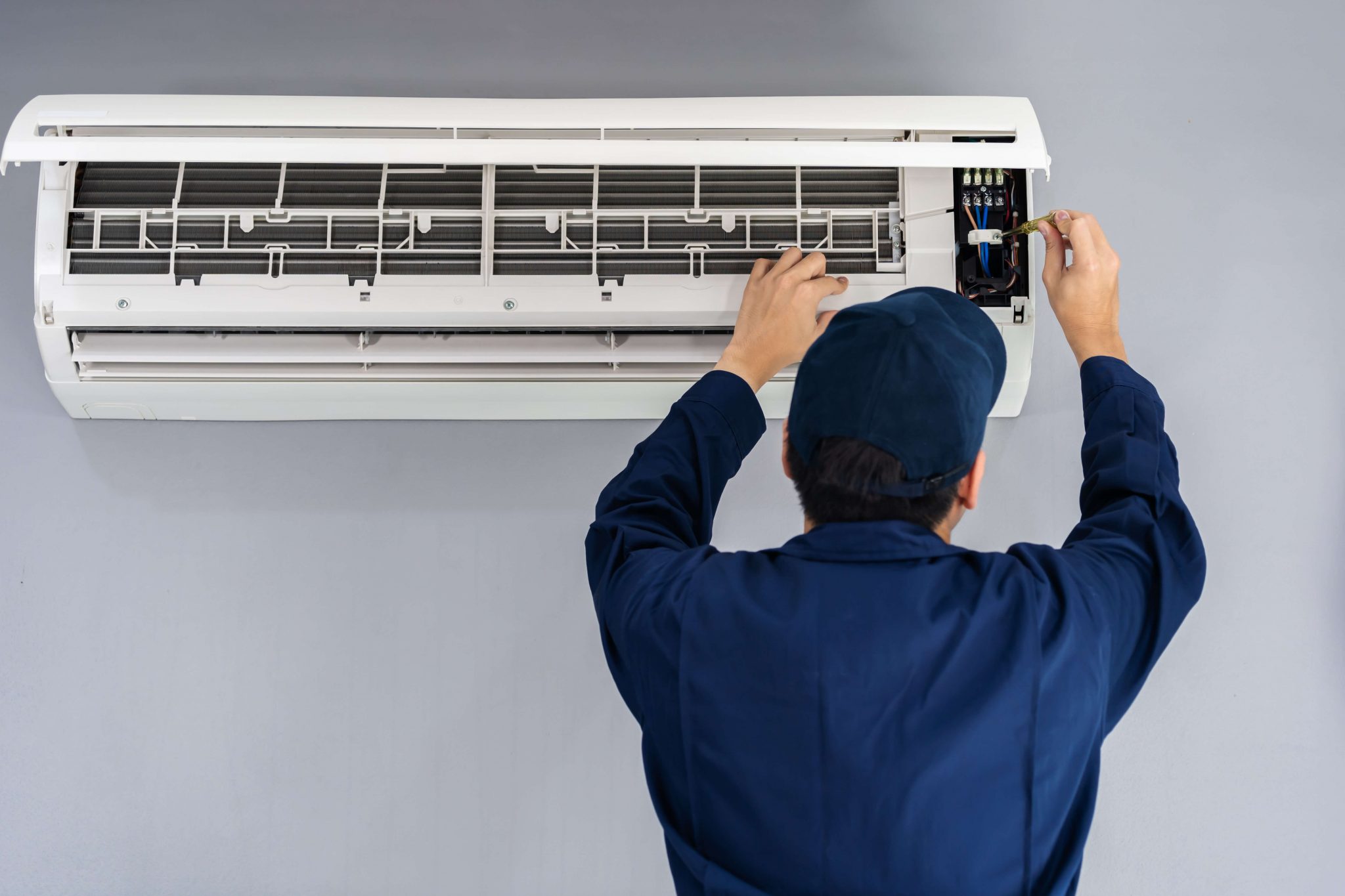 Técnico realizando manutenção de ar condicionado split
